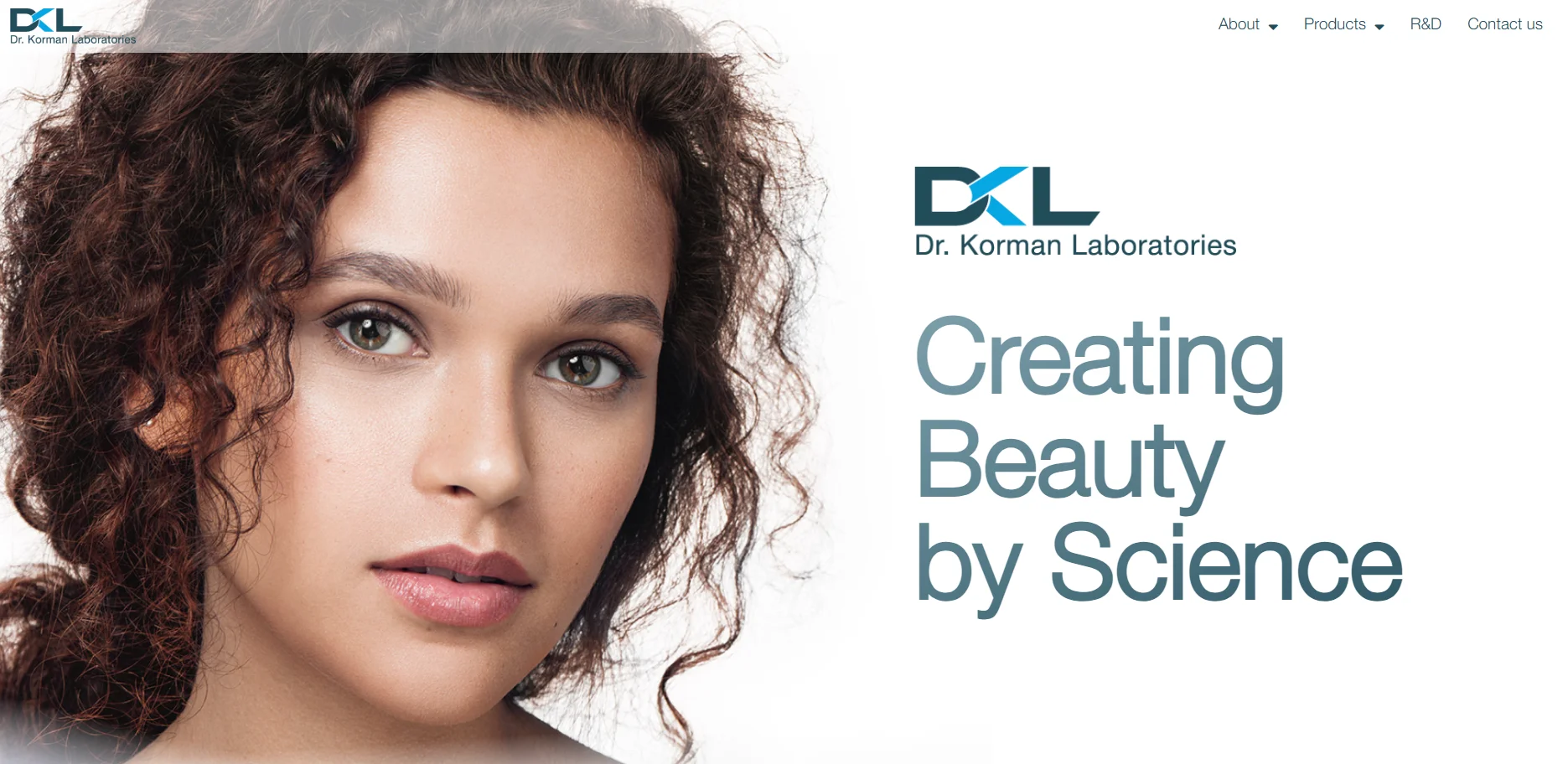 Banner for Dr. Korman Laboratories with text 'Creating Beauty by Science'. Curly hair visible on the side.